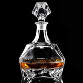 Carafe à whisky en cristal taillé, photographiée sur fond noir façon packshot studio.