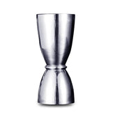 Mesure de bar double en acier inoxydable argenté, photographiée sur fond blanc.