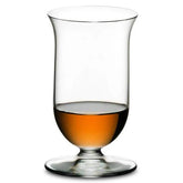 Verre à whisky à pied Riedel photographié en packshot sur fond blanc, rempli de whisky ambré.