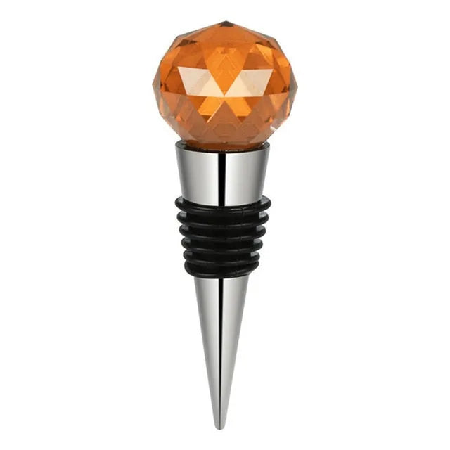 Bouchon de bouteille en forme de bille en cristal orange facetté sur embout inox, fond blanc
