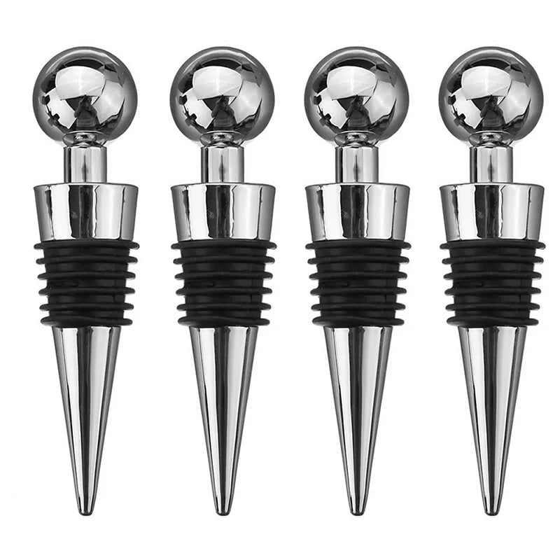 Lot de quatre bouchons de bouteille en acier inoxydable à poignée sphérique et joint en caoutchouc noir, présentés sur fond blanc.