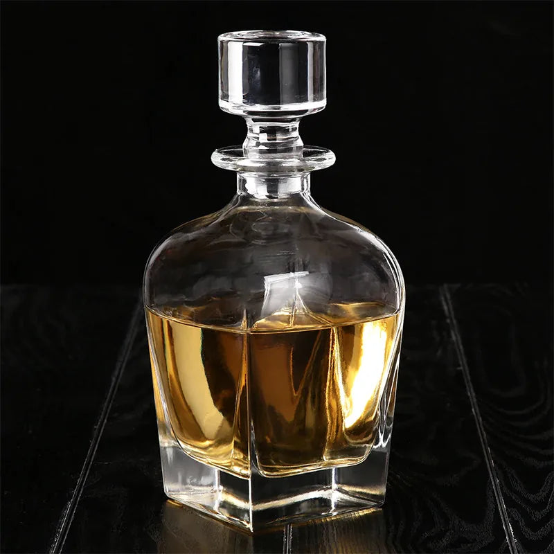 Carafe à whisky en cristal remplie d'alcool ambré, photographiée sur fond noir.
