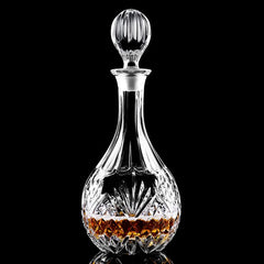 Carafe à whisky en cristal taillé posée sur fond noir avec reflet, remplie de whisky ambré