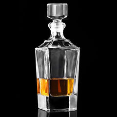 Carafe à whisky américaine en verre taillé remplie de whisky ambré, photographiée sur fond noir avec reflet au sol.