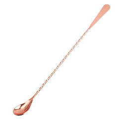 Cuillère à cocktail grande taille en finition bronze, présentée sur fond blanc