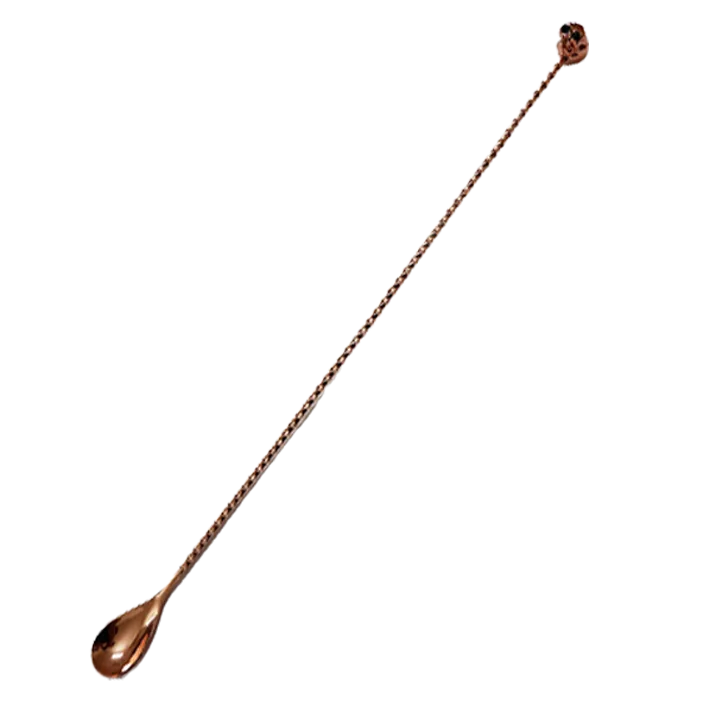 Cuillère à cocktail tête de mort en finition cuivrée, vue complète sur fond blanc.