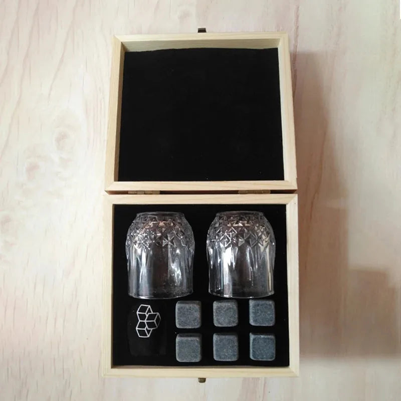 Vue de dessus du coffret en bois ouvert du kit de verres à whisky, avec les 2 verres en cristal et les 6 pierres alignées