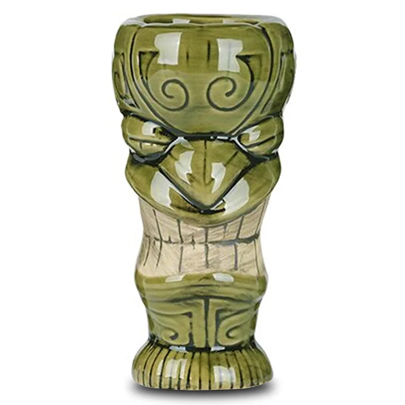 Verre à cocktail tiki vert au visage souriant, photographié de face sur fond blanc.